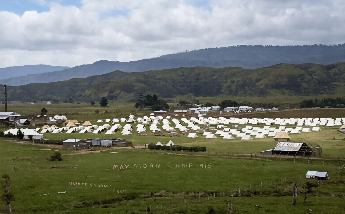 Rows of Army tents filling the valley floor at May Morn Camp in 1915, with the mill chimney at the left
